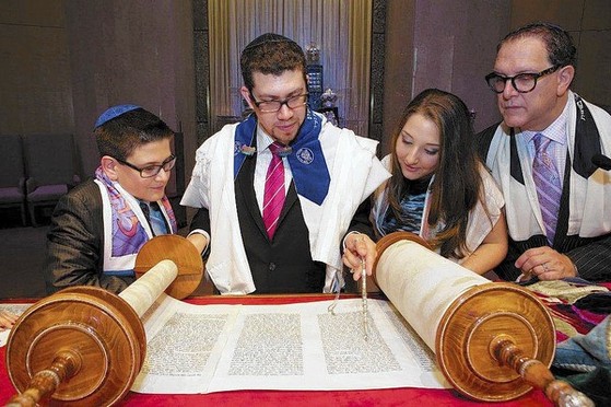 Cantor Benjamin Tisser assists Noah Viselman and his parents Leslie and Jeffrey Viselman during Noah’s bar mitzvah in November of last year at B’nai Torah Congregation. (Submitted photo)